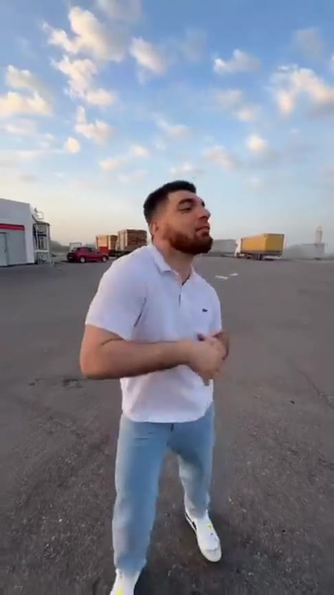 Gas Station Dance AI example: three friends take turns dancing for a selfie camera at a gas station at sunset
